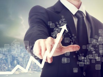Businessman Touching a Graph Indicating Growth